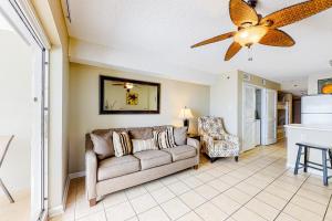a living room with a couch and a ceiling fan at Tradewinds Condos II in Orange Beach