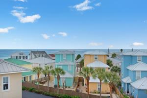 a row of houses with the ocean in the background at Emerald Coast Cabana in Panama City Beach