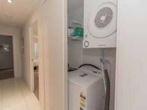 a small room with a refrigerator and a fan at Edge 6 16 Clyde Street in Jindabyne
