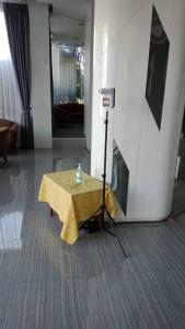 a table with a yellow table cloth on it in a room at K.S.Pavilion Hotel in Nakhon Ratchasima