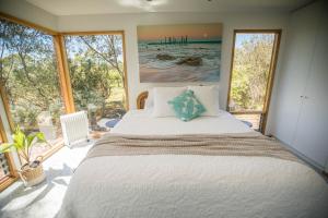 A bed or beds in a room at Sellicks Chills Vineyard Retreats