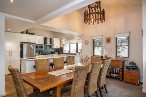 a kitchen and dining room with a wooden table and chairs at Alinga in Dinner Plain