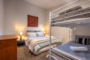 a bedroom with two bunk beds and a desk at Alinga in Dinner Plain