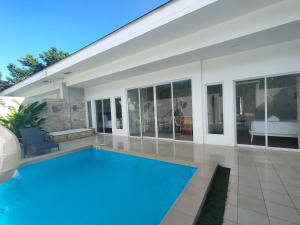 a swimming pool in the middle of a house at Pineale Villas, Resort and Spa in Panglao Island