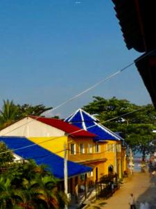 a building with a colorful roof on a street at M'pay Bay Guesthouse in Koh Rong Sanloem