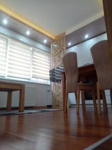 a dining room with a wooden table and chairs at Apartman Perkovic in Pale