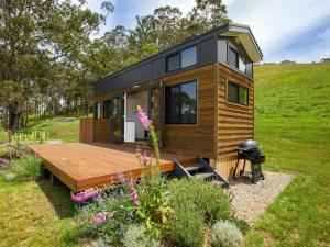a tiny house with a deck and a grill at Stella at Kangaroo Valley - Amazing Views - Fire Pit in Barrengarry +17 photos