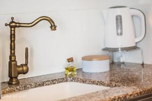 a kitchen counter with a sink and a faucet at Luxury Apartment on the Lake in Tiberias