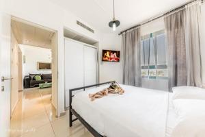 a bedroom with a white bed and a living room at Luxury Apartment on the Lake in Tiberias +20 photos