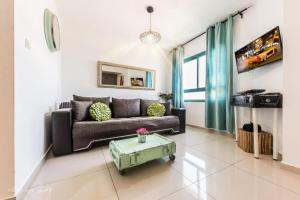 a living room with a couch and a table at Luxury Apartment on the Lake in Tiberias