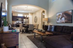 a living room with a couch and a table at Gated townhouse with heated pool, hot tub, near US60 in Mesa