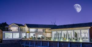 a large house with a full moon in the sky at No Flowers Boutique Hostel in Kunming