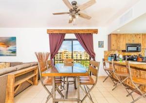 a living room with a table and a couch at Right on the Beach! Ocean Front 2 Story Penthouse in Puerto Peñasco