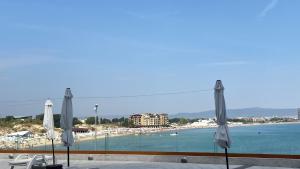 a view of a beach from a balcony with umbrellas at PARADISO 'В' 107 Private Cozy Studio NESSEBAR in Nesebar