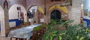 un comedor con mesa y algunas plantas en Casa rural con piscina y pista de padel - Casa de Pacas, en Bolaños de Calatrava
