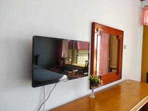 a flat screen tv hanging on a wall at Bukit Kenari Hotel & Restaurant in Parepare