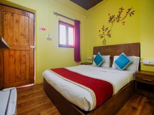 a bedroom with a large bed and a window at Mariners Bay Beach Resort in Arambol
