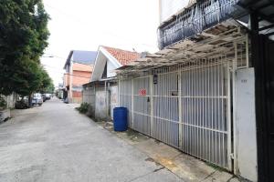 an alley with a fence next to a building at Eiffel Residence Batu Tulis 35A1 - Female Only in Jakarta