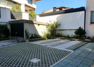 an empty courtyard with a grate in front of a building at Tuzlaks appartment in Sarajevo