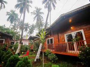 a resort with palm trees in the background at Mariners Bay Beach Resort in Arambol