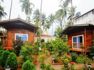a house with a garden in front of it at Mariners Bay Beach Resort in Arambol
