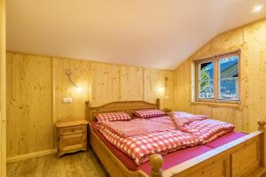 a bedroom with a bed in a wooden room at Ferienwohnung Rubin in Mittenwald