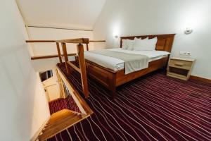 a bedroom with a large bed in a room at Boutique Damiani in Sibiu +37 photos