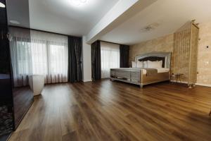a bedroom with a bed and a hard wood floor at Boutique Damiani in Sibiu