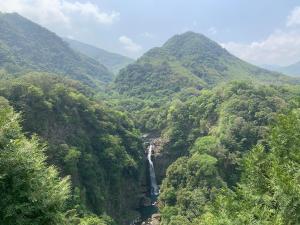 a view of a mountain valley with a waterfall at Forgather B&B in Sanmin