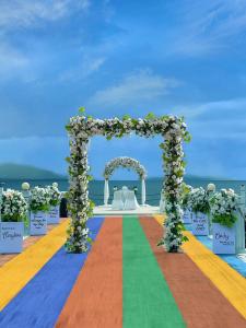 an aisle with an arch with a rainbow at NDC Resort & Spa in Manado
