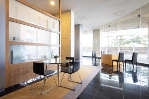a dining room with a glass table and black chairs at Home2Book Amazing View Apart Floor 25 Santa Cruz in Santa Cruz de Tenerife