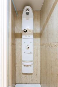 a bathroom with a washer and dryer on the wall at Home2Book Amazing View Apart Floor 25 Santa Cruz in Santa Cruz de Tenerife