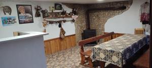 a living room with a table and a stove at Guest House Proynovi in Kalofer