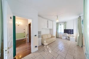 a large living room with a couch and a television at Agriturismo Le Meridiane in Borgomaro