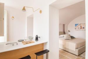 a bathroom with a sink and a bed in a room at Palazzo Mulini in Monopoli