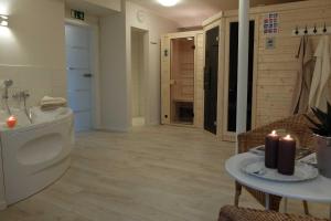 a bathroom with a toilet and a table with candles at Ferienwohnung Innenhof in Pommerby