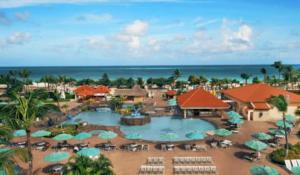 a resort with a pool and chairs and umbrellas at La Cabana BRC Studio & Apartment in Palm-Eagle Beach