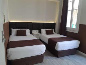 A bed or beds in a room at BCN Urbaness Hotels Bonavista
