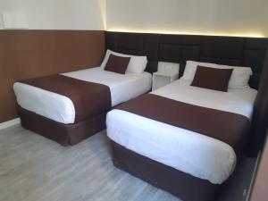 A bed or beds in a room at BCN Urbaness Hotels Bonavista