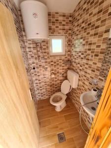 a small bathroom with a toilet and a sink at Srce Kozare in Prijedor