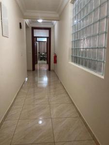 a hallway with a tile floor in a building at Bertha's Court D-Plus Apartments in Greenhill
