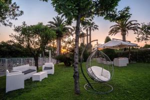 a swing in the grass next to a tree at Hotel Alpha in Sant'Agnello