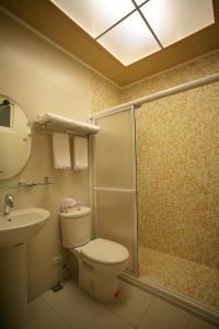 a bathroom with a shower and a toilet and a sink at Heart Stay in Hualien City