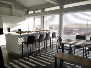a kitchen with a bar with chairs and tables at Green Village in Mikolaivka