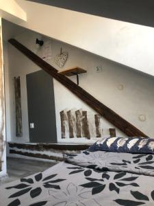 a bedroom with a bed and a staircase on the wall at Bingi in Krakow