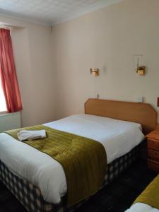 Giường trong phòng chung tại Inglewood Palm Hotel, Abbey Sands Torquay