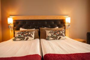 a bedroom with a large bed with two pillows at Spar Hotel Majorna in Gothenburg