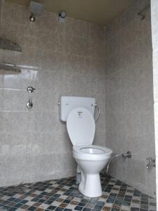 a bathroom with a toilet and a shower at Mountain Whisper, Most Unique Location in Rishikesh in Rishīkesh