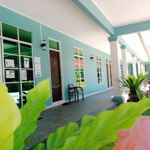 a building with a blue wall and a door at D'EMBUN INAP DESA BESUT in Kampung Raja
