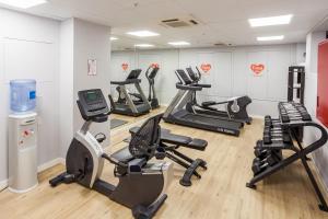 a gym with several treadmills and cardio machines at Hotel Royal Passeig de Gracia in Barcelona